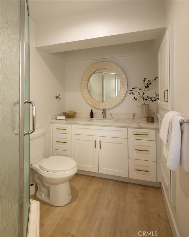 1436 W Bay Ave, Newport Beach, CA 92661 - bathroom with wood finished floors, toilet, a stall shower, and vanity