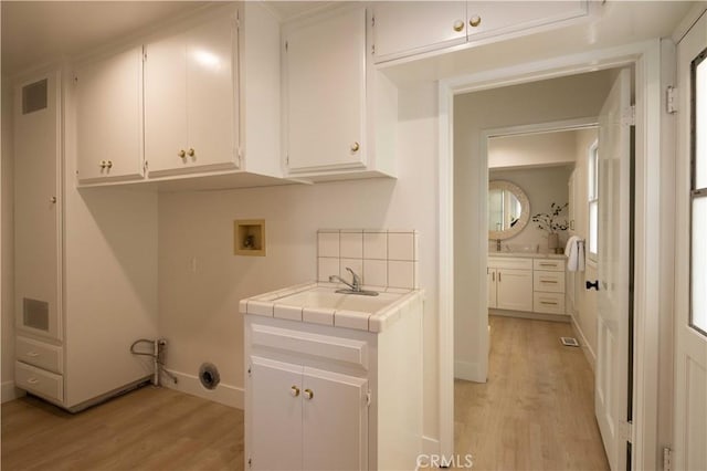 1436 W Bay Ave, Newport Beach, CA 92661 - laundry room featuring cabinet space, light wood finished floors, and hookup for a washing machine