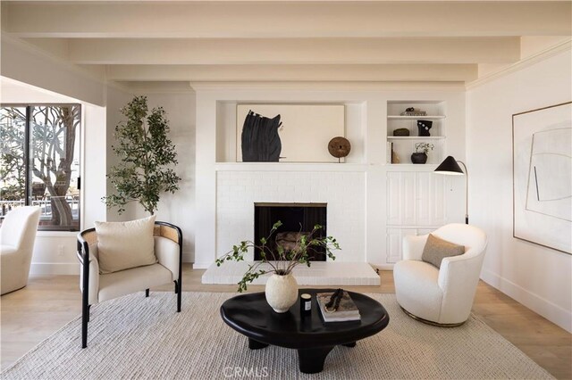 1436 W Bay Ave, Newport Beach, CA 92661 - sitting room featuring wood finished floors, baseboards, beam ceiling, built in shelves, and a brick fireplace