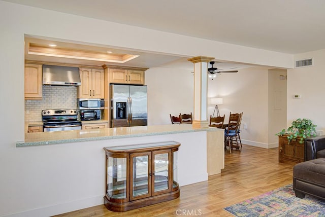 829 Via Alhambra Unit A, Laguna Woods, CA 92637 - kitchen featuring appliances with stainless steel finishes, wall chimney exhaust hood, a raised ceiling, a ceiling fan, and baseboards