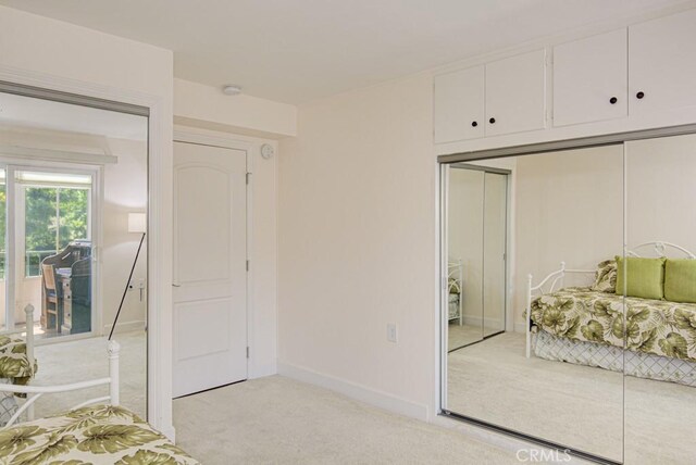 829 Via Alhambra Unit A, Laguna Woods, CA 92637 - bedroom with light carpet, baseboards, and a closet