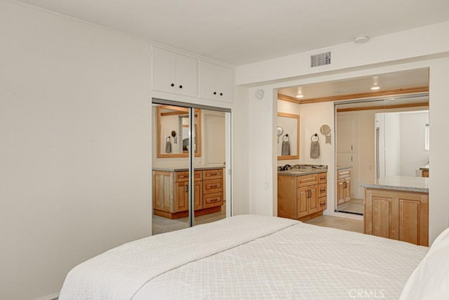 829 Via Alhambra Unit A, Laguna Woods, CA 92637 - bedroom featuring a sink, connected bathroom, and light tile patterned floors