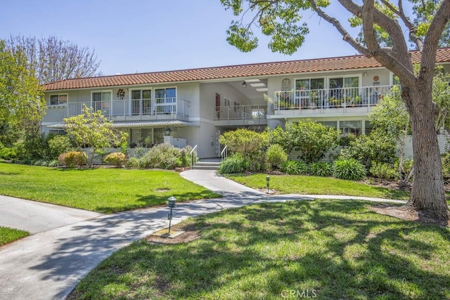 829 Via Alhambra Unit A, Laguna Woods, CA 92637 - view of front of home featuring stucco siding, a tile roof, and a front yard