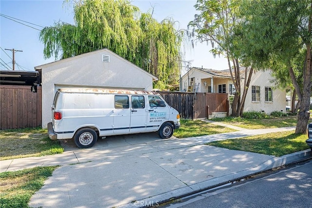 5503 Hersholt Ave, Lakewood, CA 90712 - view of front of home with fence, a garage, a gate, and driveway
