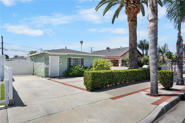 5150 W 135th St, Hawthorne, CA 90250 - view of front of home featuring a gate, stucco siding, and driveway