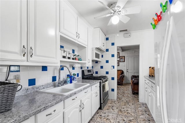 5150 W 135th St, Hawthorne, CA 90250 - kitchen featuring gas stove, a sink, white microwave, ceiling fan, and white cabinetry