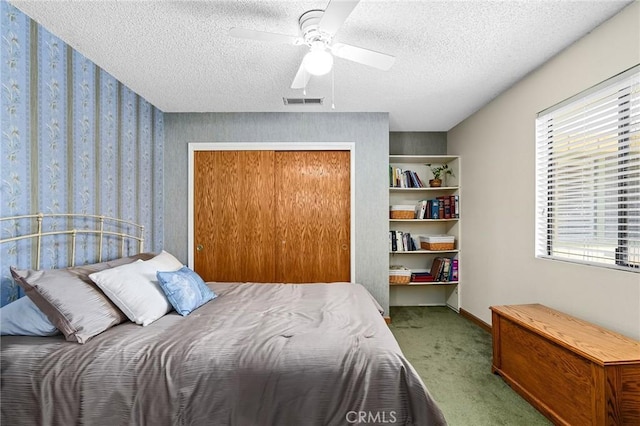 5456 Edith Ave, Corning, CA 96021 - carpeted bedroom featuring multiple windows, wallpapered walls, a textured ceiling, a closet, and a ceiling fan