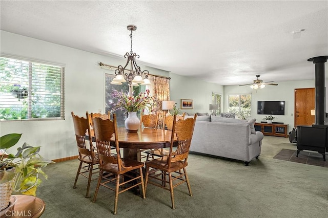 5456 Edith Ave, Corning, CA 96021 - carpeted dining space with a wood stove, plenty of natural light, a textured ceiling, and ceiling fan