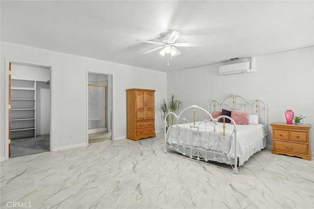 5456 Edith Ave, Corning, CA 96021 - bedroom featuring a wall mounted AC, marble look tiles, a walk in closet, ceiling fan, and ensuite bath
