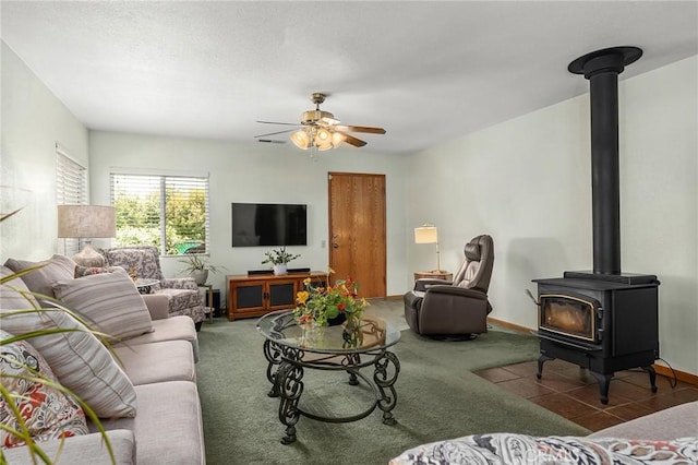 5456 Edith Ave, Corning, CA 96021 - living room featuring a wood stove, ceiling fan, and carpet