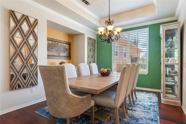 5799 Buckthorn Ave, Rancho Cucamonga, CA 91737 - dining space featuring a chandelier, baseboards, a tray ceiling, dark wood-style flooring, and crown molding