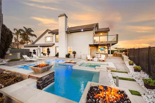 2 Hyannis, Laguna Niguel, CA 92677 - back of house featuring a fire pit, a balcony, a patio, and a fenced backyard