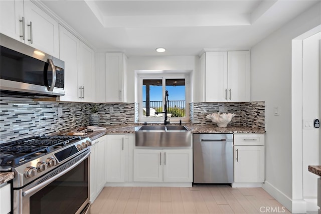 2 Hyannis, Laguna Niguel, CA 92677 - kitchen with appliances with stainless steel finishes, a raised ceiling, white cabinets, light stone countertops, and recessed lighting