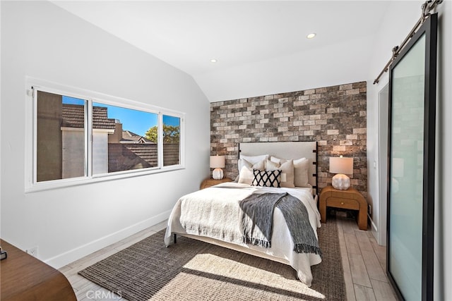 2 Hyannis, Laguna Niguel, CA 92677 - bedroom with a barn door, lofted ceiling, light wood-type flooring, baseboards, and recessed lighting