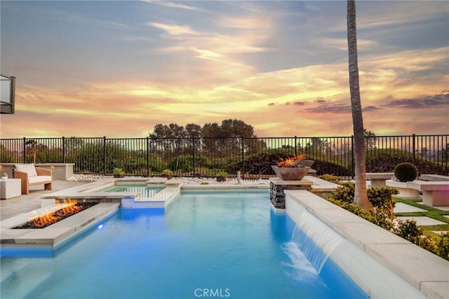 2 Hyannis, Laguna Niguel, CA 92677 - pool at dusk featuring a fire pit, a pool with connected hot tub, and fence