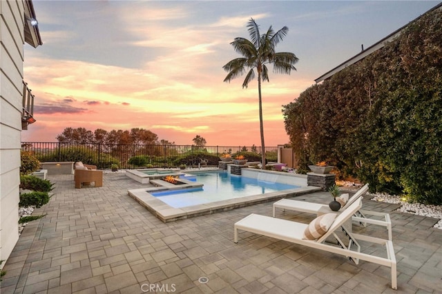 2 Hyannis, Laguna Niguel, CA 92677 - pool at dusk with an in-ground hot tub, a patio, and a fenced backyard