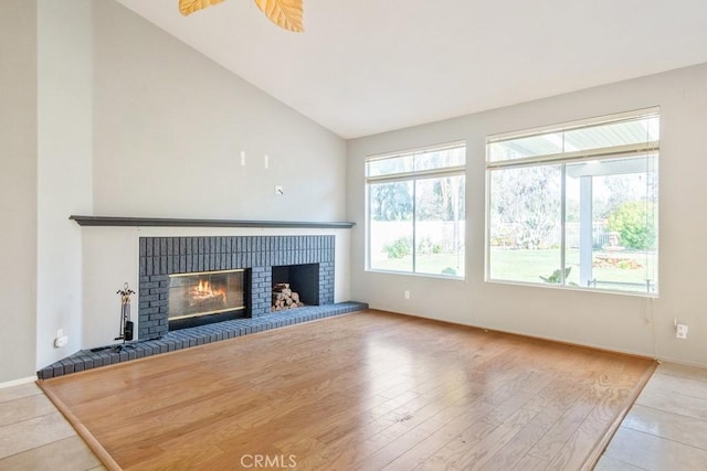 32364 Corte Coronado, Temecula, CA 92592 - unfurnished living room with a brick fireplace, baseboards, tile patterned flooring, and high vaulted ceiling