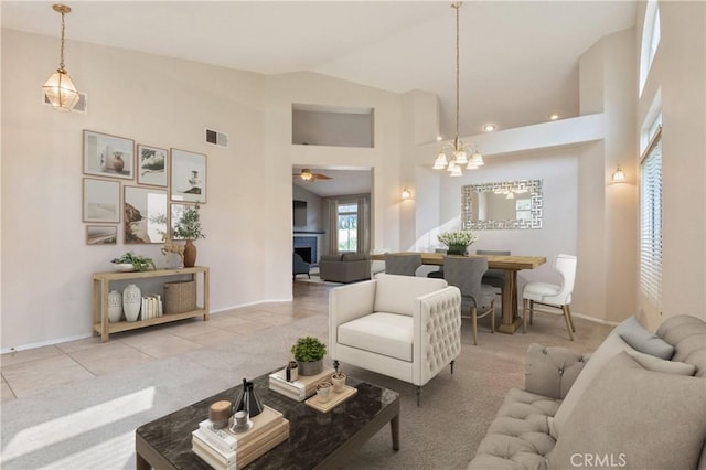 32364 Corte Coronado, Temecula, CA 92592 - carpeted living area featuring high vaulted ceiling, a chandelier, tile patterned flooring, a ceiling fan, and a fireplace