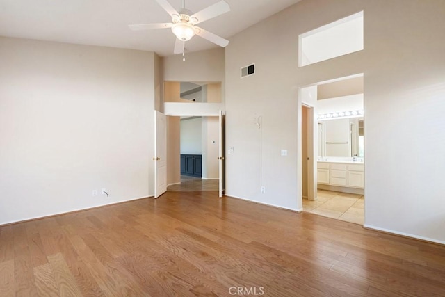 32364 Corte Coronado, Temecula, CA 92592 - unfurnished bedroom featuring a high ceiling, light wood-style flooring, and connected bathroom