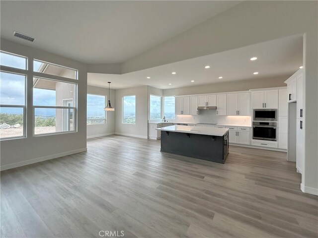 12460 San Marcos Rd, Atascadero, CA 93422 - kitchen with oven, recessed lighting, built in microwave, a center island, and light countertops