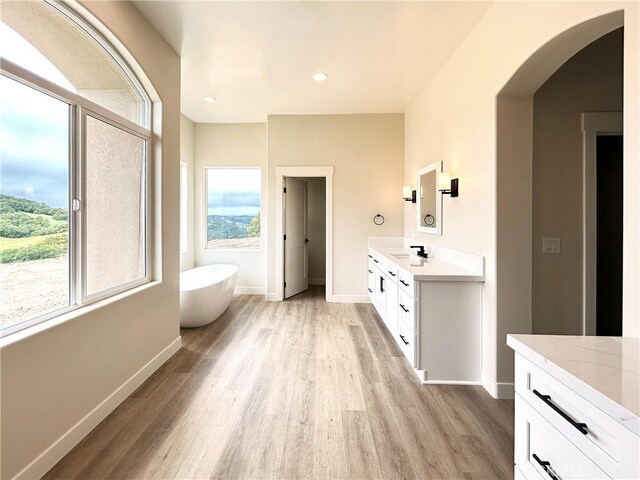 12460 San Marcos Rd, Atascadero, CA 93422 - full bath with double vanity, healthy amount of natural light, wood finished floors, and recessed lighting