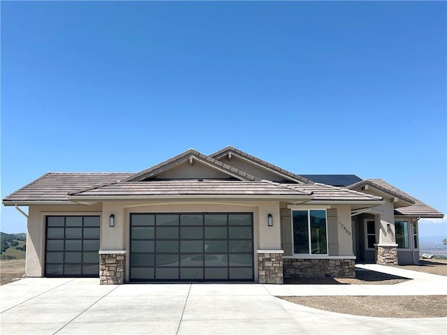 12460 San Marcos Rd, Atascadero, CA 93422 - view of front facade with stone siding, an attached garage, stucco siding, and a tile roof