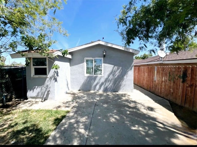 1324 Murdock St, Bakersfield, CA 93307 - rear view of house featuring stucco siding, fence, and a patio area