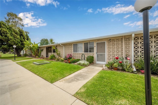 ranch-style home with a front lawn
