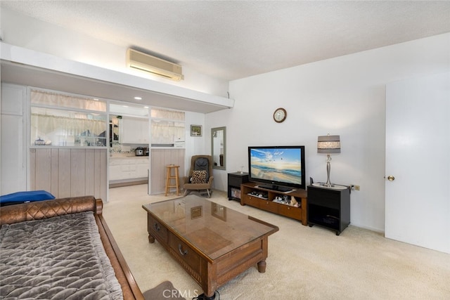 living room with a wall unit AC and light carpet