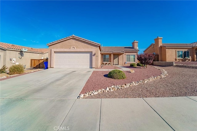 view of front facade featuring an attached garage, a chimney, concrete driveway, stucco siding, and a tiled roof