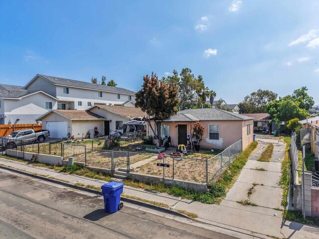 23537 S Willie James Jones Ave, San Diego, CA 92113 - view of front facade with concrete driveway, a residential view, and a fenced front yard