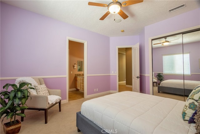 41380 La Sierra Rd, Temecula, CA 92591 - carpeted bedroom with a textured ceiling, ensuite bathroom, a closet, a ceiling fan, and baseboards
