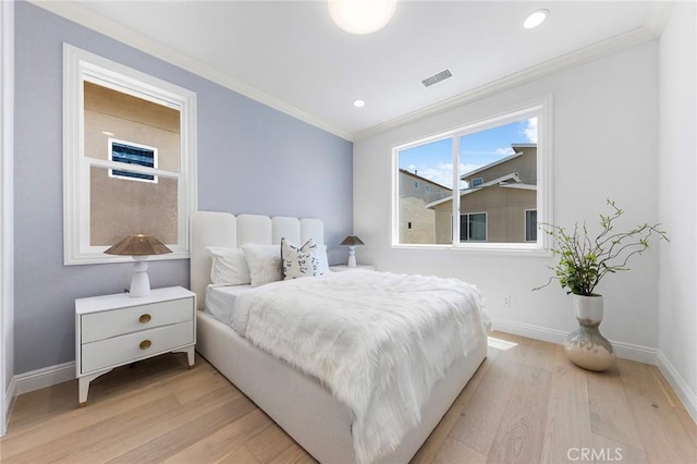 bedroom with light wood finished floors, ornamental molding, baseboards, and recessed lighting