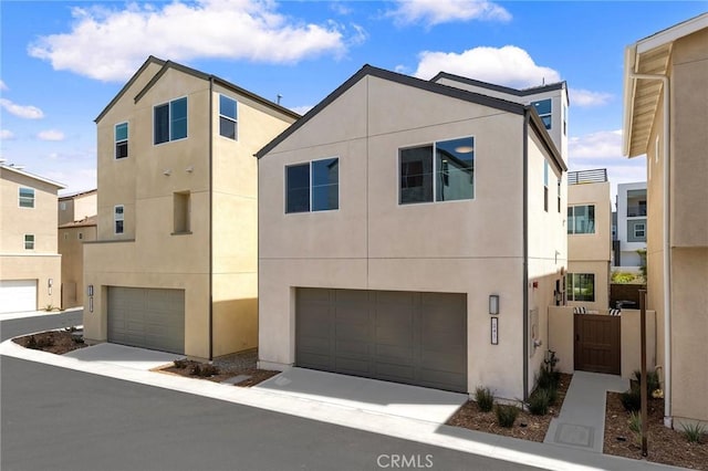 multi unit property featuring stucco siding and a garage