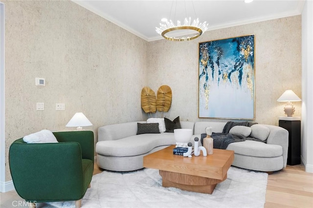 living area featuring wood finished floors, ornamental molding, and a chandelier