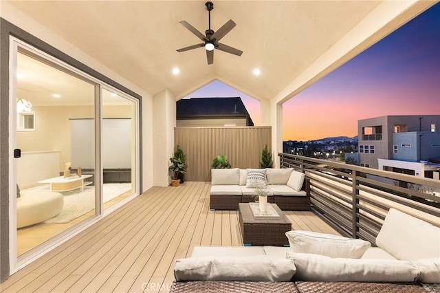 deck at dusk featuring an outdoor hangout area and ceiling fan