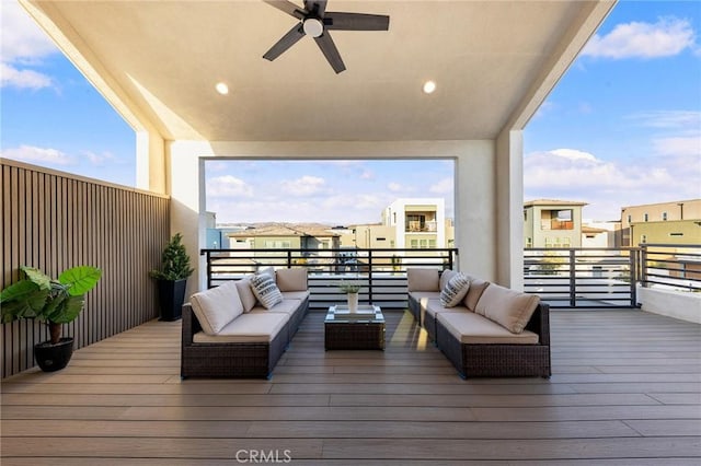 wooden terrace featuring an outdoor living space and a ceiling fan