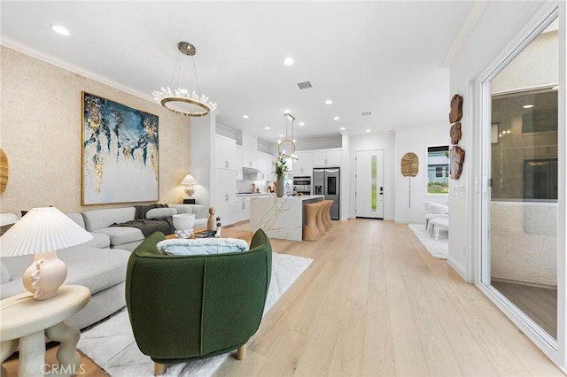 living room with light wood-type flooring, recessed lighting, and crown molding