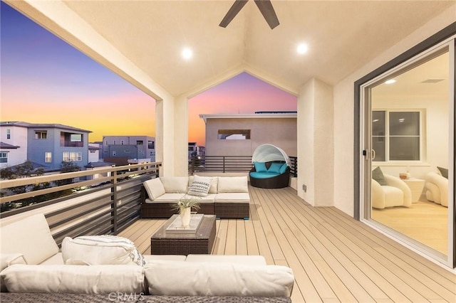 balcony at dusk with an outdoor living space and ceiling fan