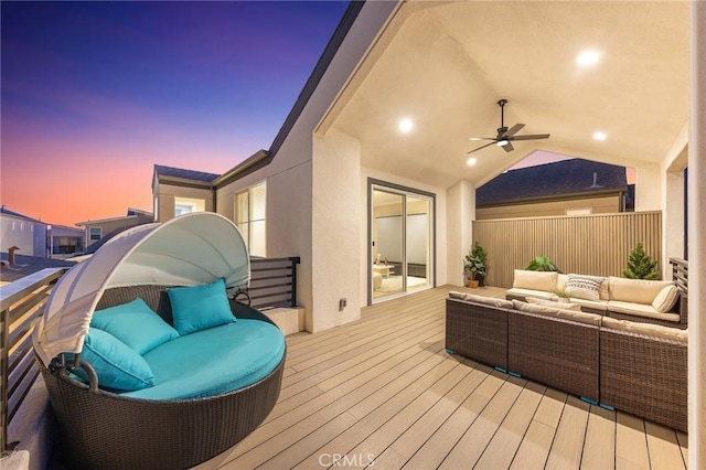 wooden deck featuring an outdoor living space and ceiling fan