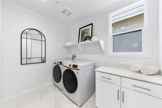 washroom featuring light marble finish floors, separate washer and dryer, ornamental molding, cabinet space, and baseboards