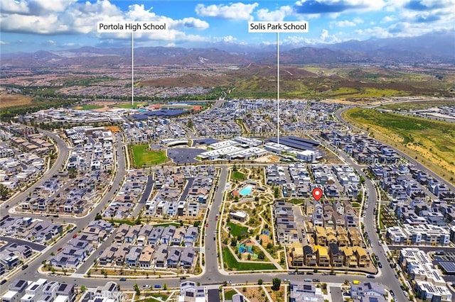 aerial view of property and surrounding area featuring a mountain backdrop