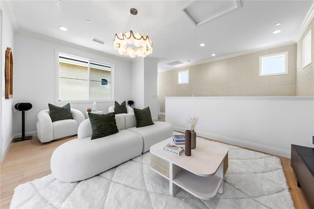 living area featuring crown molding, attic access, wood finished floors, healthy amount of natural light, and recessed lighting