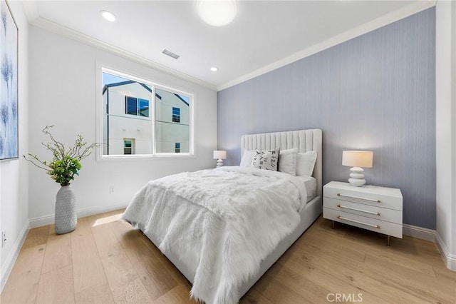 bedroom with light wood-style floors, baseboards, crown molding, and recessed lighting