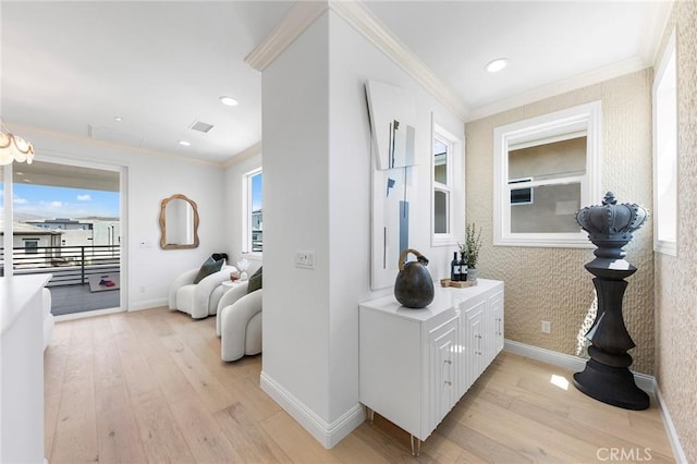 corridor featuring baseboards, light wood-style floors, crown molding, wallpapered walls, and recessed lighting