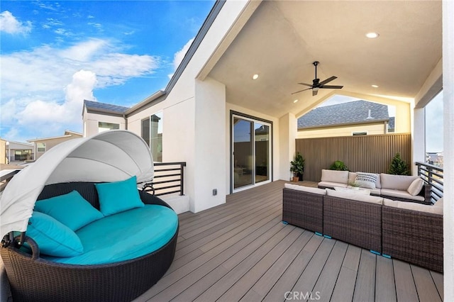 wooden terrace featuring an outdoor living space and a ceiling fan