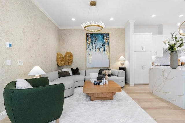 living area with light wood-style flooring, crown molding, recessed lighting, and a chandelier