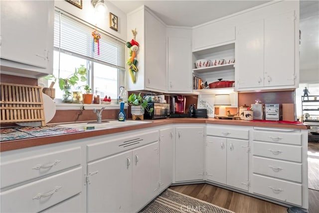 7405 El Camino Real, Atascadero, CA 93422 - kitchen featuring wood finished floors, white cabinetry, and a sink