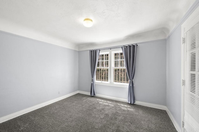 carpeted spare room with baseboards