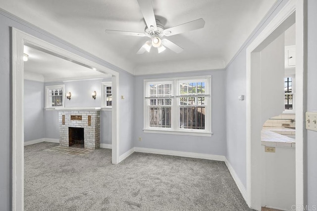unfurnished living room with carpet, a ceiling fan, and healthy amount of natural light